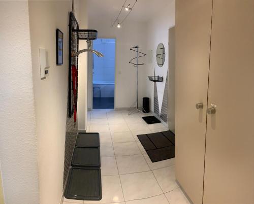 a hallway with a stairway leading to a bathroom at Quellenhof C01 in Davos