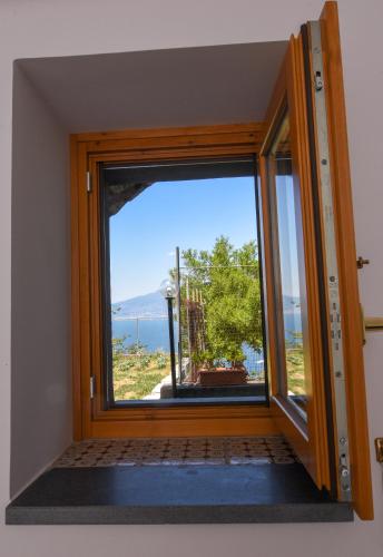 a door with a window with a view at Villa Mariagiovanna - Casa Giovanna in Vico Equense