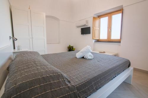a bedroom with a large bed in a room at Villa Mariagiovanna - Casa Giovanna in Vico Equense