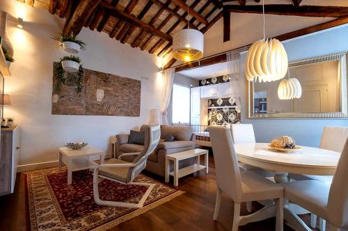 a dining room and living room with a table and chairs at La Casa nel Castello in Ostia Antica