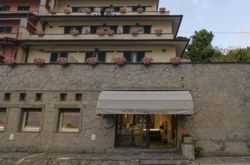 a store front of a building with flower boxes on it at Hotel Villa Argentina in Riomaggiore