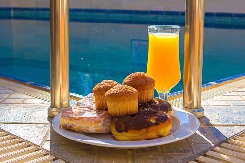 a plate of donuts and a glass of orange juice at Anthena Studios in Skiathos Town
