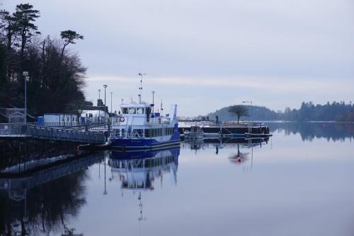 a boat is docked at a dock in the water at Tirchonaill Townhouse in Donegal