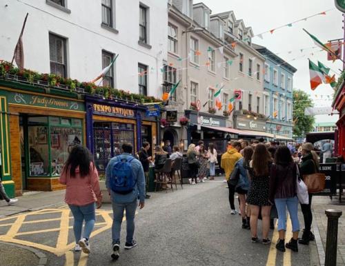 a group of people walking down a busy city street at 7 Boutique Hotel in Galway