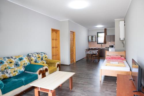 a living room with a couch and a table at Apartman Centrum in Mórahalom