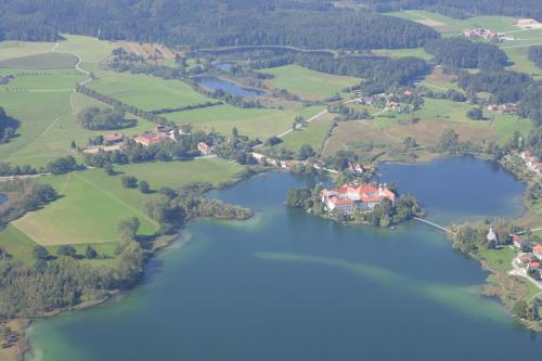 an aerial view of a lake with houses and trees at Haus Rufinus am Kloster Seeon in Seeon-Seebruck