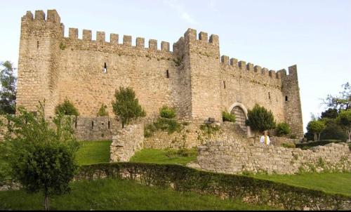 a woman standing in front of a castle at Galerias 90 in Pombal