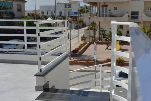 a stairway with white railings on a city street at The Simo's House Camere a Marzamemi in Marzamemi