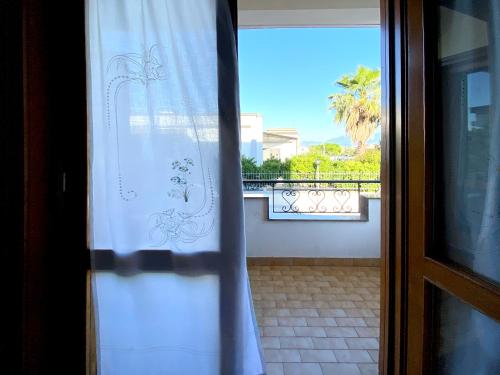 a door with a window with a view of a balcony at Giannì Holiday Home - Vesuvio/Pompei in Terzigno