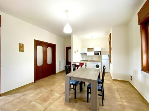 a dining room and kitchen with a table and chairs at Giannì Holiday Home - Vesuvio/Pompei in Terzigno