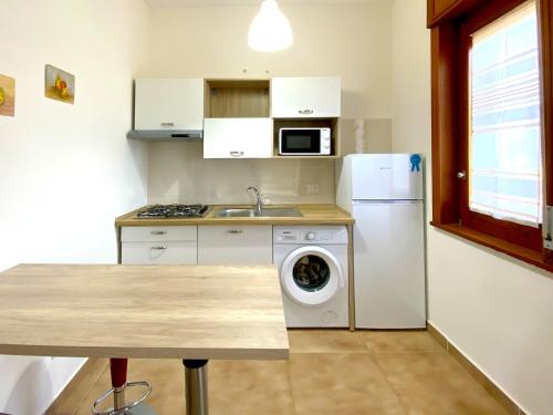 a kitchen with a white refrigerator and a washing machine at Giannì Holiday Home - Vesuvio/Pompei in Terzigno
