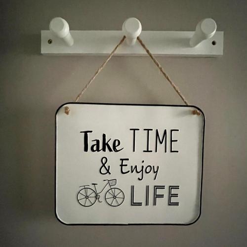 Un signe qui dit que prendre du temps et profiter de la vie dans l'établissement Cafe Velo Nevers, à Nevers