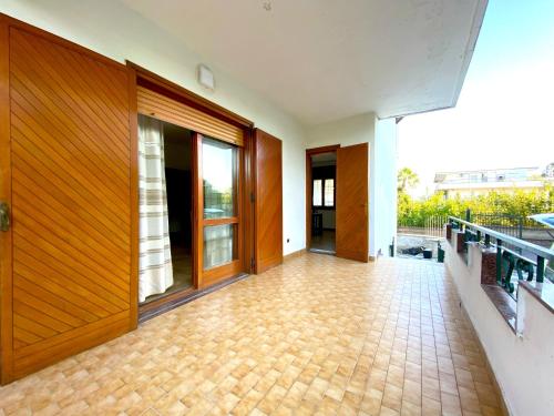 an empty hallway with wooden doors and a tile floor at Giannì Holiday Home - Vesuvio/Pompei in Terzigno