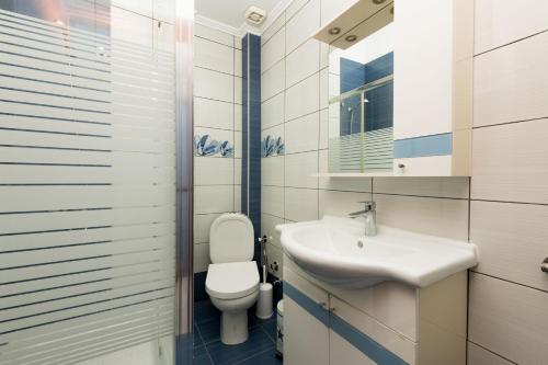 a bathroom with a toilet and a sink at Luxury Dream House in Limenaria