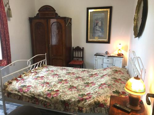 a bedroom with a bed and a table with a lamp at Vintage House for rent 60m from Sea in Baška Voda