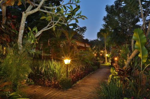 a street light in a garden at night at Bliss Ubud Spa Resort in Ubud