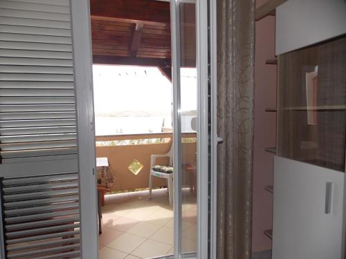 a view of a kitchen through a sliding glass door at Apartments Vivien in Kustići