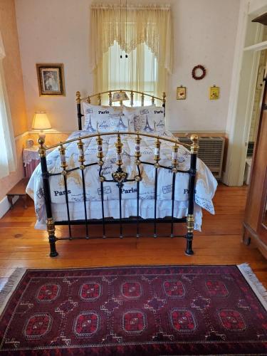 a canopy bed in a bedroom with a rug at American River Inn in Georgetown