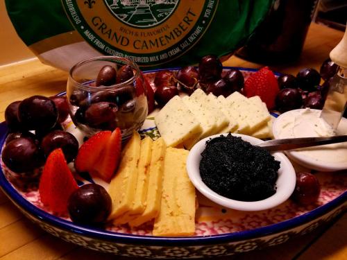 a plate of food with cheese and fruit on a table at American River Inn in Georgetown