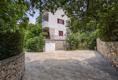 an exterior view of a house with a driveway at Jees Exclusive Apartments Hvar in Stari Grad