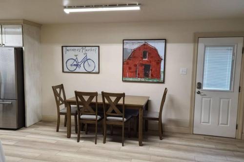 a dining room with a table and chairs and a bike on the wall at Farm House stay with soaking tub and hot tub barn in Hammond