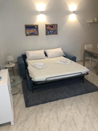 a bed in a room with two pillows on it at Rio Apartment cà di Euro with parking in Riomaggiore