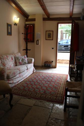 a living room with a couch and an open door at B&B Vecchia Suppenna in Andria