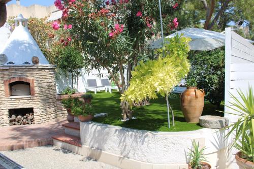 a garden with a brick fireplace and a tree at B&B Vecchia Suppenna in Andria