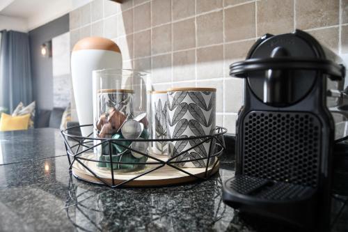 a kitchen counter with a coffee maker and a bowl of fruit at Palm Cove - 10 Thira, Santorini, best view over Thompsons Beach in Ballito