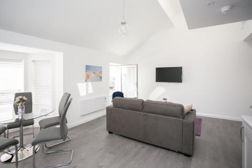 a living room with a couch and a table at 107 Eglinton Street in Portrush