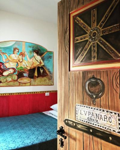 a door to a room with a painting on the wall at Hotel Europeo Napoli in Naples