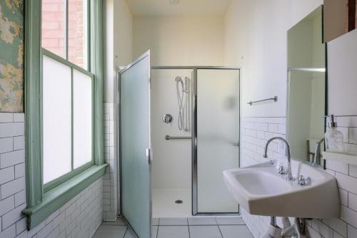 a bathroom with a sink and a shower at Hostel Fish in Denver