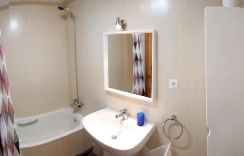 a white bathroom with a sink and a mirror at Bonus Dei - 5934 in Isla