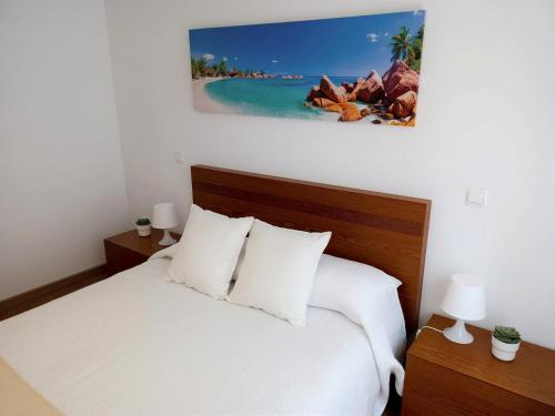 a bedroom with a white bed with white pillows at Bonus Dei - 5934 in Isla