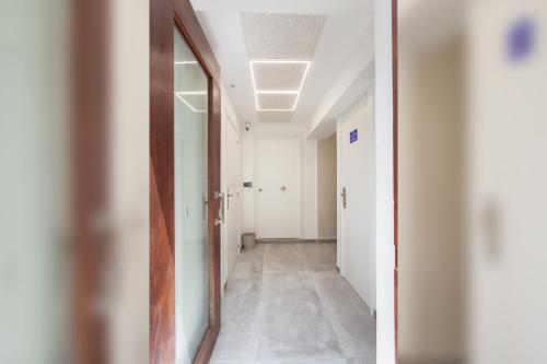 a hallway in an office building with a mirror at Sueño de Elvira in Granada