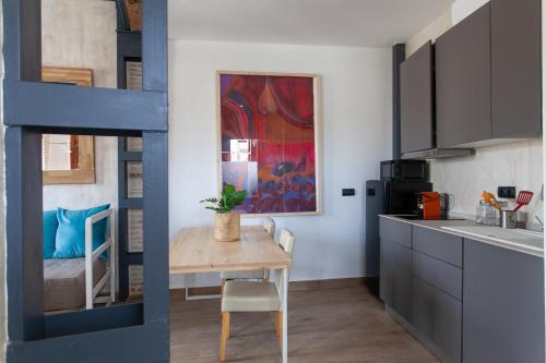 a kitchen with a small table and a kitchen with a bed at Sueño de Elvira in Granada