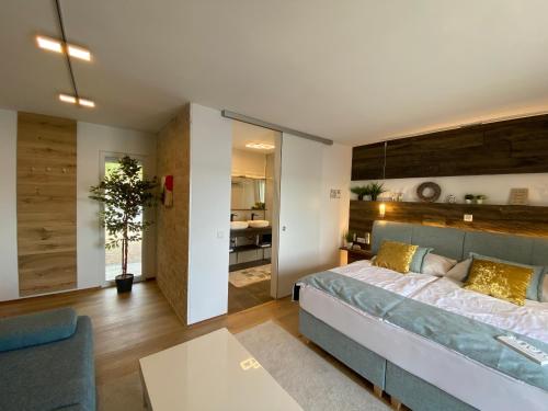 a bedroom with a bed and a living room at VILLA OD MOORE STARIGRAD in Starigrad-Paklenica