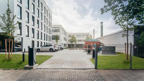 a street with cars parked in front of a building at kalm stay - munich east in Munich