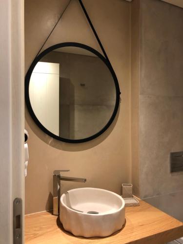 a round sink in a bathroom with a mirror at Toxotis Villas in Armenistis