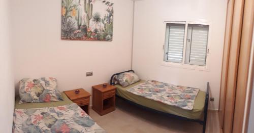 a room with two beds and a window at FRAMANTIS App No 6 in Costa Calma