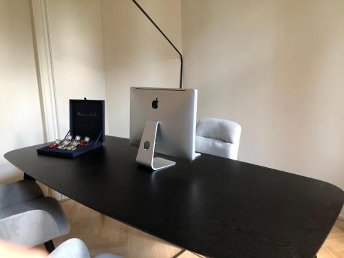 a black table with an apple computer on top of it at The Scent Residence in Antwerp
