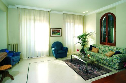 a living room with a couch and a table at Villa Helvetia in Grottammare