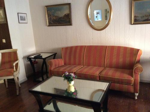 a living room with a couch and a coffee table at Cavalieri Hotel in Corfu Town