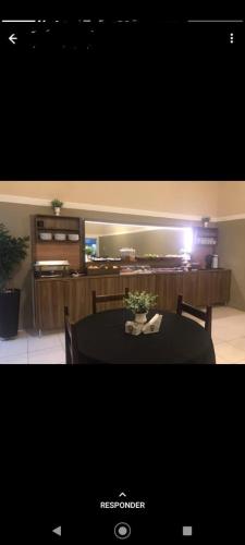 a dining room with a table with a black table cloth at Hotel Loren in Bauru