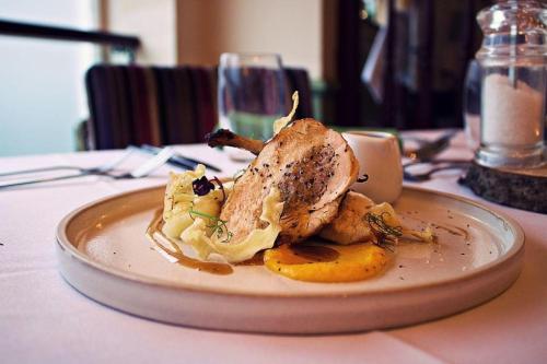 a chicken sitting on a plate on a table at The George Inn in Barton-upon-Humber
