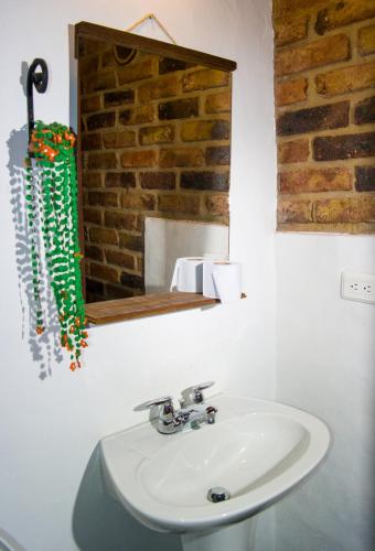 a bathroom with a sink and a mirror at Posada San Esteban in Sutamarchán