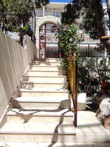 a set of stairs with a gate and flowers at Apartment Topic in Baška Voda