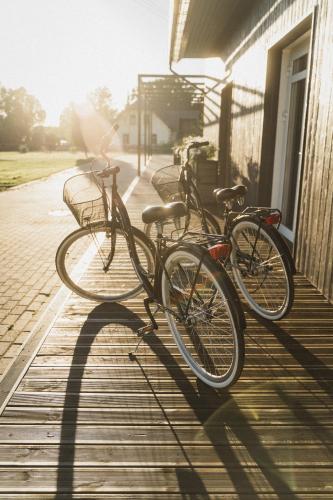 a group of bikes parked next to a building at Guest House Garoza with Self Check-in in Tūja