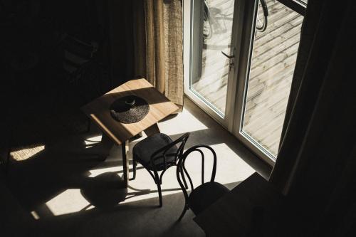 a room with a table and a chair and a window at Guest House Garoza with Self Check-in in Tūja