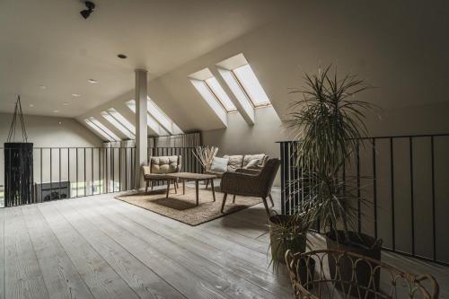 a living room with a couch and a table at Guest House Garoza with Self Check-in in Tūja